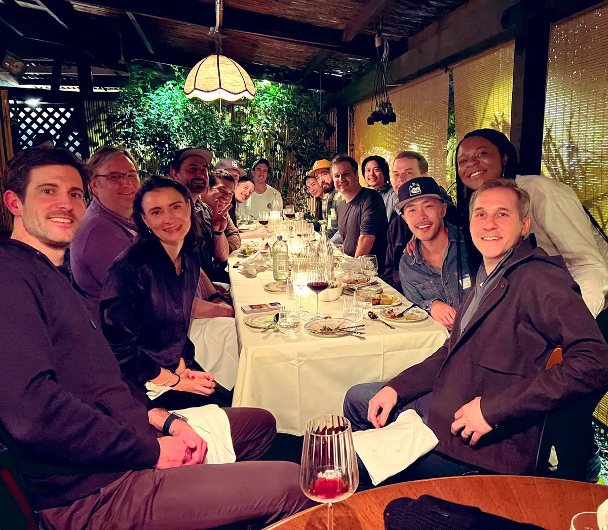 A PROOF Collective dinner around a long table with Kevin Rose and Justin Mezzell, with Rob Iula seated across from them